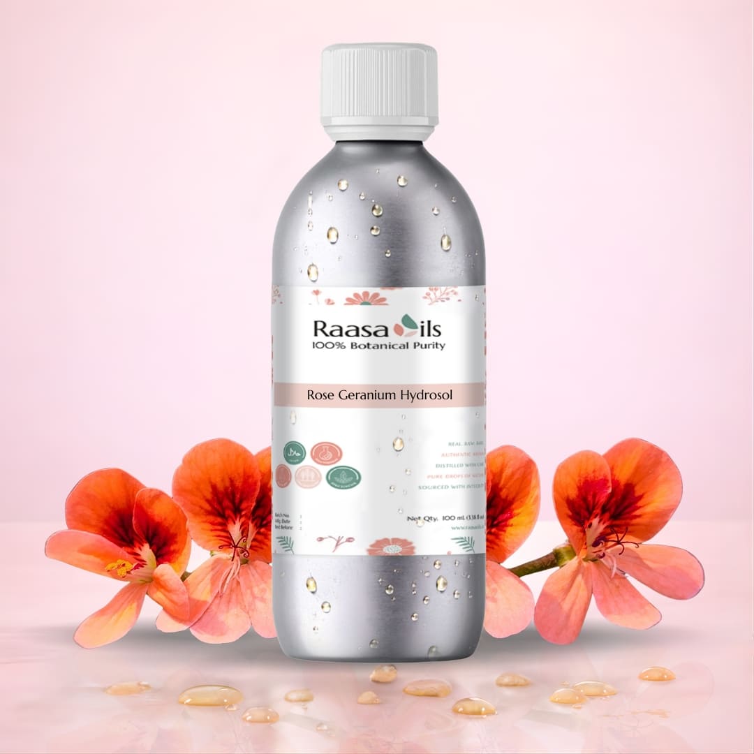 Raasa Oils Rose Geranium Hydrosol bottle with flowers on a pink background