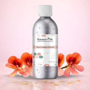 Raasa Oils Rose Geranium Hydrosol bottle with flowers on a pink background