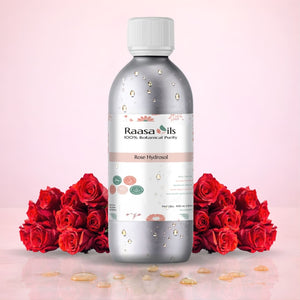 Bottle of Raasa Oils Rose Hydrosol with red roses on a pink background