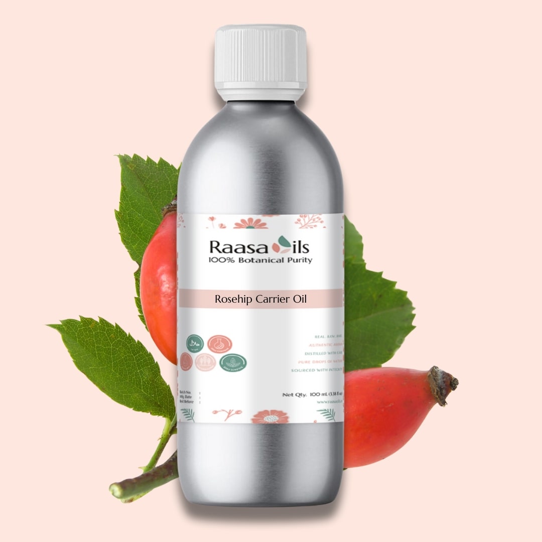 Bottle of Raasa Oils Rosehip Carrier Oil with rosehip fruit and leaves on a light pink background