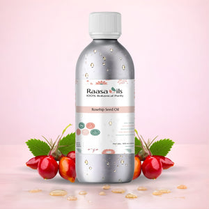 Bottle of Raasa Oils Rosehip Carrier Oil with rosehip fruit and leaves on a light pink background