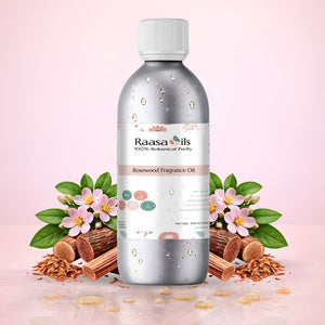 Raasa Oils bottle with rosewood and flowers on a pink background