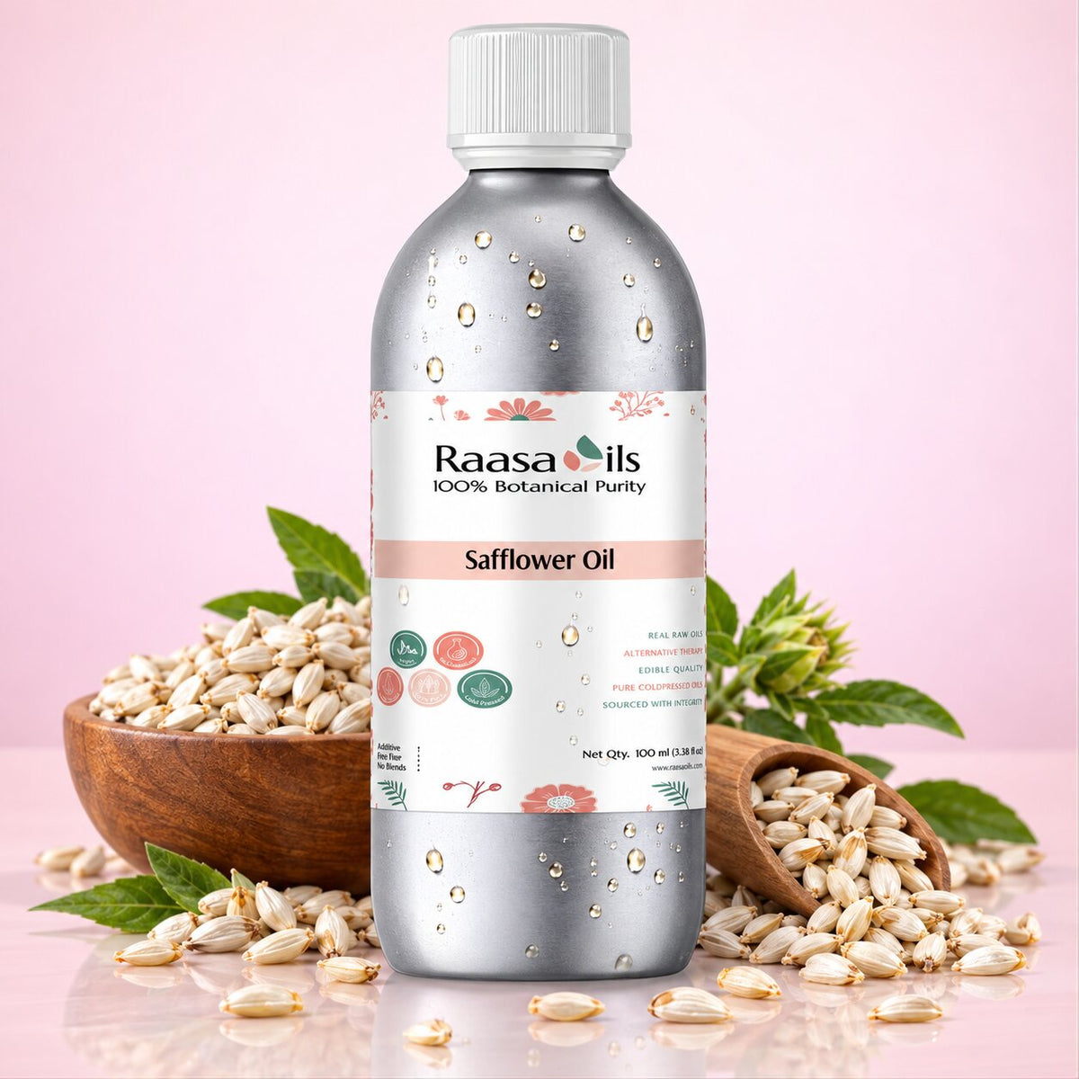 A bottle of Raasa Oils Safflower Oil centered on a soft pink background, surrounded by green safflower flowers and yellow blooms with a few oil droplets near the base.