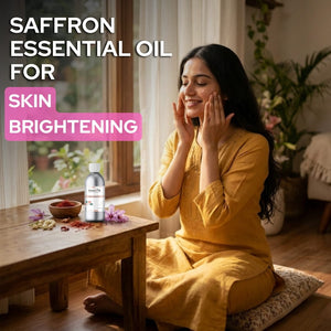 Woman applying saffron essential oil for skin brightening in a home setting.