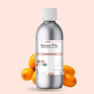 Bottle of Raasa Oils Sea Buckthorn Oil with sea buckthorn fruits on a light pink background