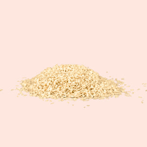 Heap of sesame seeds on a beige background