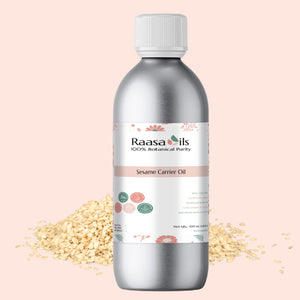 Bottle of Raasa Oils Sesame Carrier Oil with sesame seeds on a light pink background