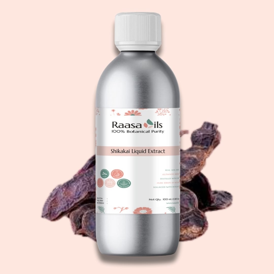 Bottle of Raasa Oils Shikakai Liquid Extract with dried shikakai leaves on a pink background