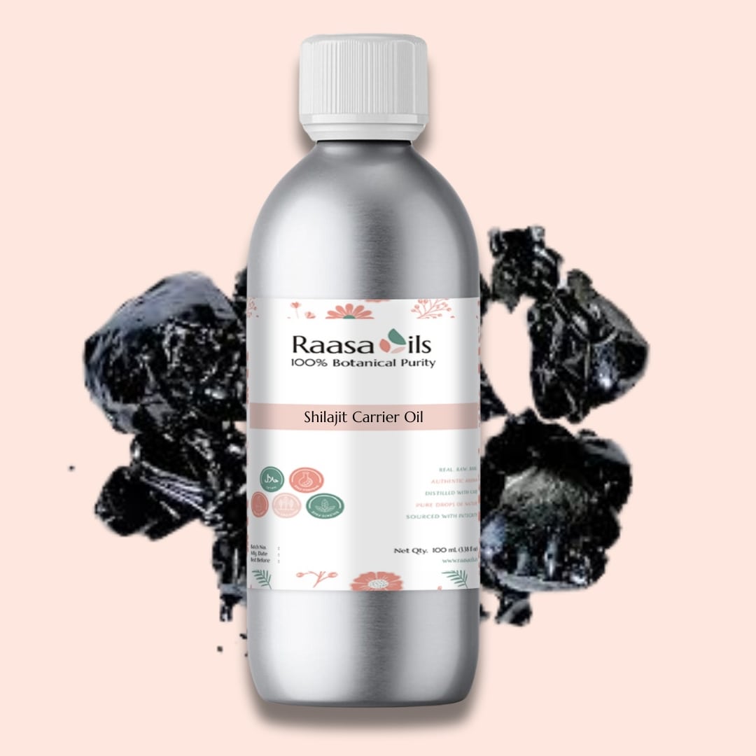 Bottle of Raasa Oils Shilajit Carrier Oil with black shilajit pieces on a pink background