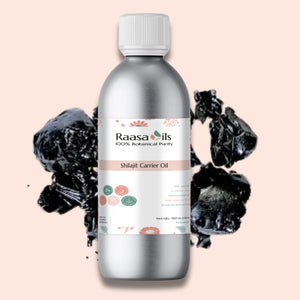 Bottle of Raasa Oils Shilajit Carrier Oil with black shilajit pieces on a pink background
