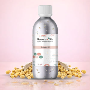 Bottle of Raasa Oils soybean oil with soybeans on a pink background