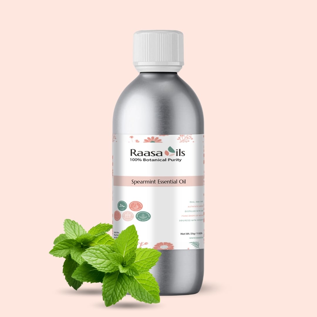 Spearmint essential oil bottle with leaves on a light pink background