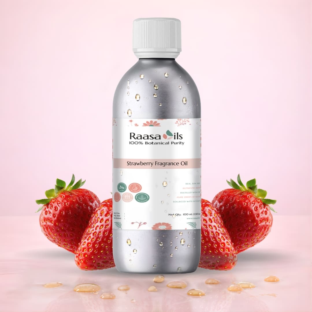 Bottle of Raasa Oils Strawberry Fragrance Oil with strawberries on a pink background