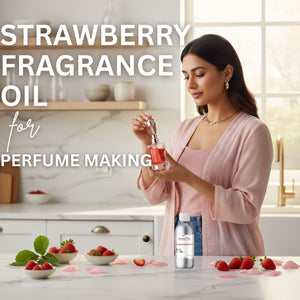Woman holding a bottle of strawberry fragrance oil with strawberries on a kitchen counter.