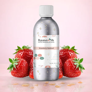 Bottle of Raasa Oils Strawberry Hydrosol with strawberries on a pink background
