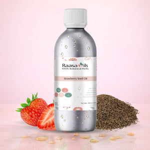 Bottle of Raasa Oils Strawberry Seed Oil with strawberries and seeds on a pink background