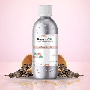 Bottle of Raasa Oils Sunflower Seed Oil with sunflower seeds on a pink background