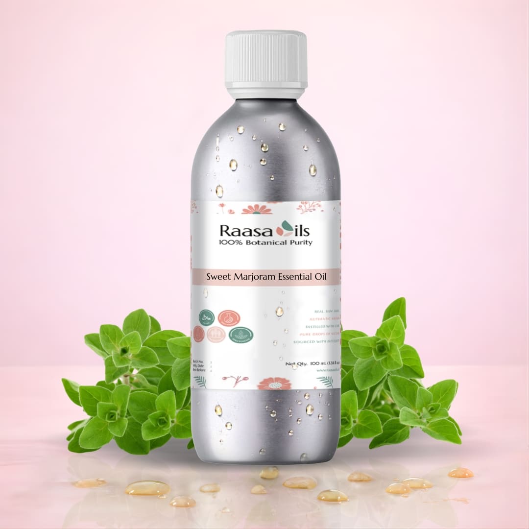 Raasa Oils Sweet Marjoram Essential Oil bottle with green leaves on a pink background