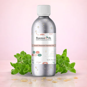 Raasa Oils Sweet Marjoram Essential Oil bottle with green leaves on a pink background