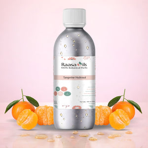 Raasa Oils Tangerine Hydrosol bottle with tangerines on a pink background
