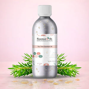 Bottle of Raasa Oils Tea Tree Essential Oil with green leaves on a pink background