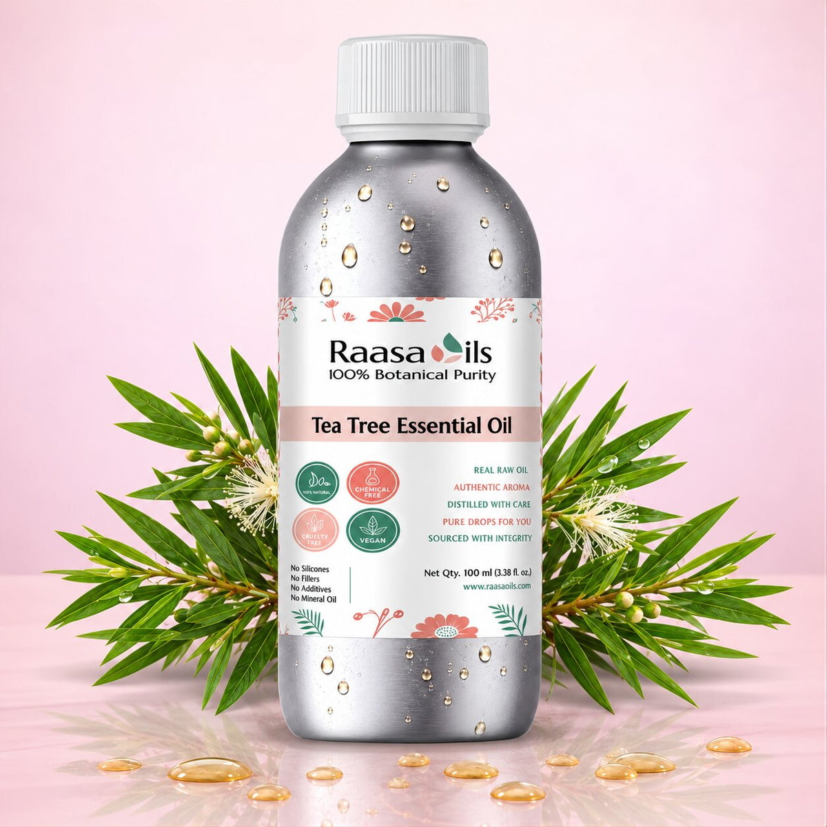 A bottle of Raasa oils Tea Tree Essential Oil centered on a pink background, flanked by green tea tree leaves and small amber droplets. The bottle is metallic silver with a white cap and a white label featuring pink and green accents.