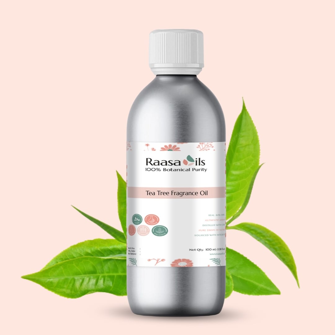 Bottle of Raasa Oils Tea Tree Fragrance Oil with green leaves on a beige background