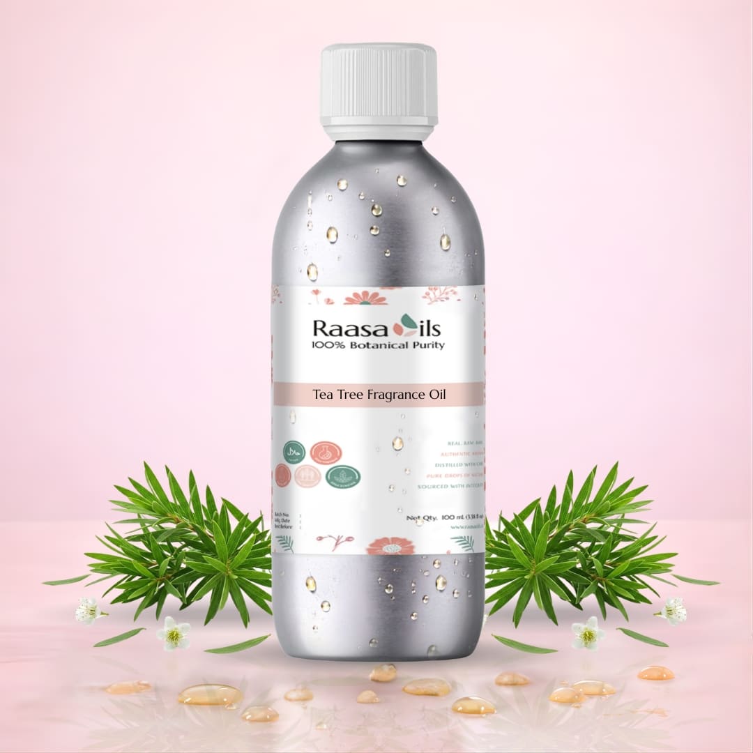 Bottle of Raasa Oils Tea Tree Fragrance Oil with green leaves and flowers on a pink background
