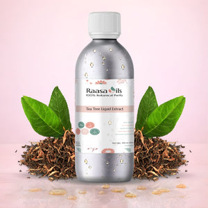 Bottle of Raasa Oils Tea Tree Liquid Extract with tea leaves and roots on a pink background