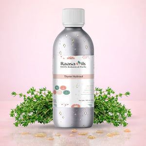 Raasa Oils Thyme Hydrosol bottle with thyme leaves on a pink background