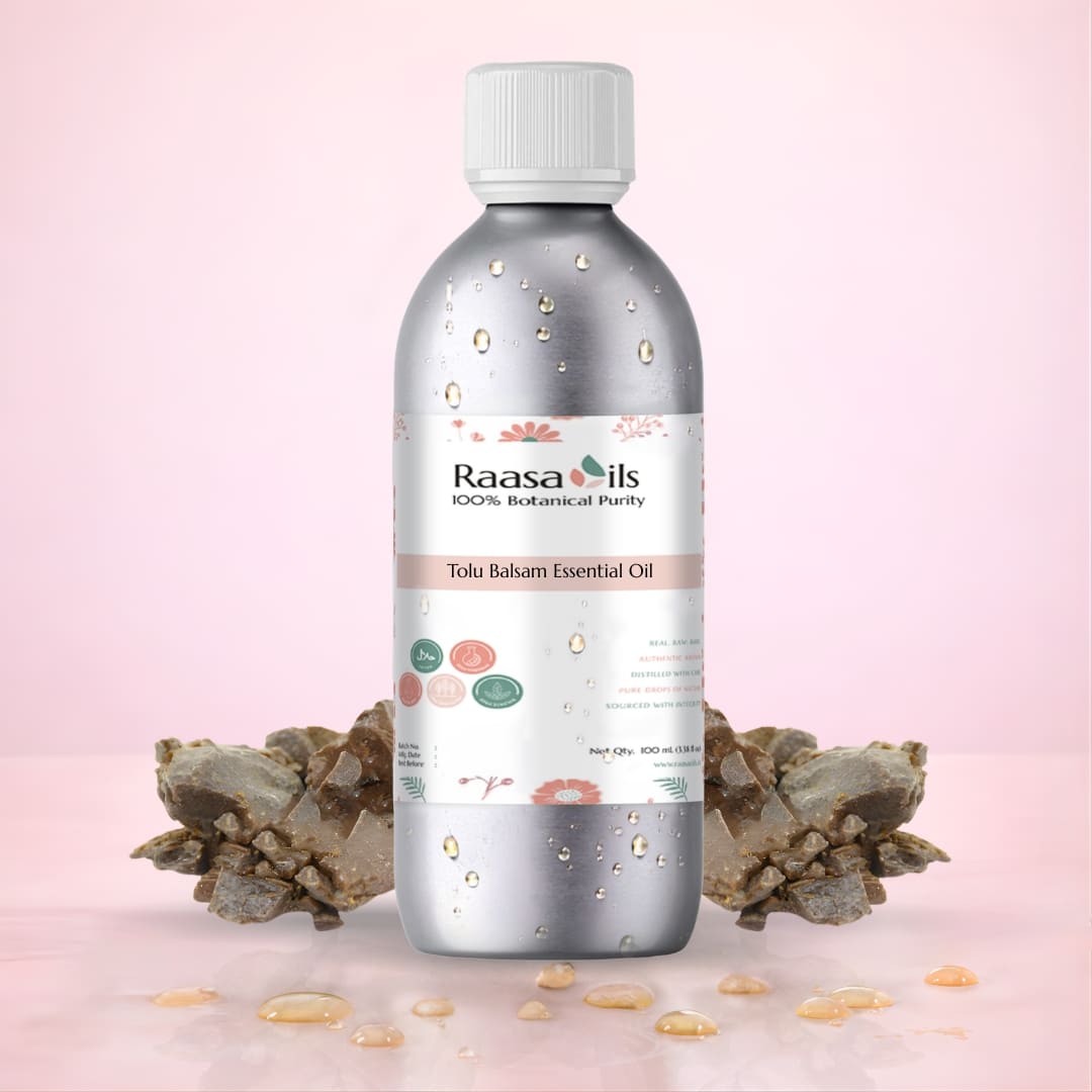 Raasa Oils Tolu Balsam Essential Oil bottle with decorative elements on a pink background