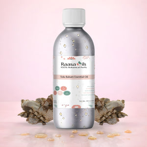 Raasa Oils Tolu Balsam Essential Oil bottle with decorative elements on a pink background