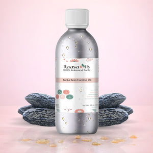 Raasa Oils Tonka Bean Essential Oil bottle with tonka beans on a pink background