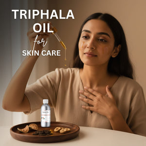 Woman applying Triphala oil to her face with a dropper, surrounded by Triphala ingredients on a wooden tray.