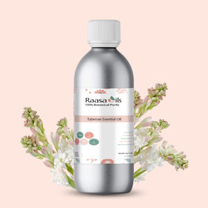 Raasa Oils Tuberose Essential Oil bottle with floral elements on a light pink background