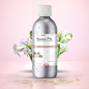 Raasa Oils Tuberose Essential Oil bottle with flowers on a pink background