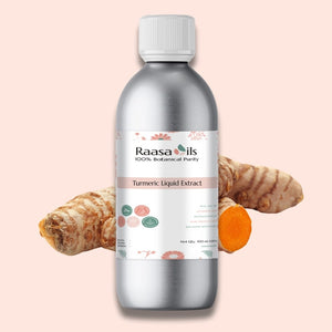 Bottle of Raasa Oils Turmeric Liquid Extract with turmeric root and turmeric root powder on a pink background