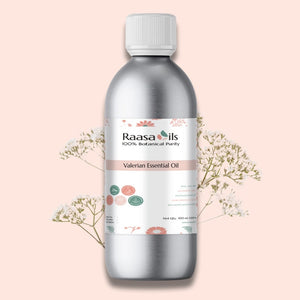 Raasa Oils Valerian Essential Oil bottle on a light pink background with decorative elements.