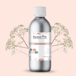 Bottle of Raasa Oils Valerian Hydrofol on a light pink background with floral elements.