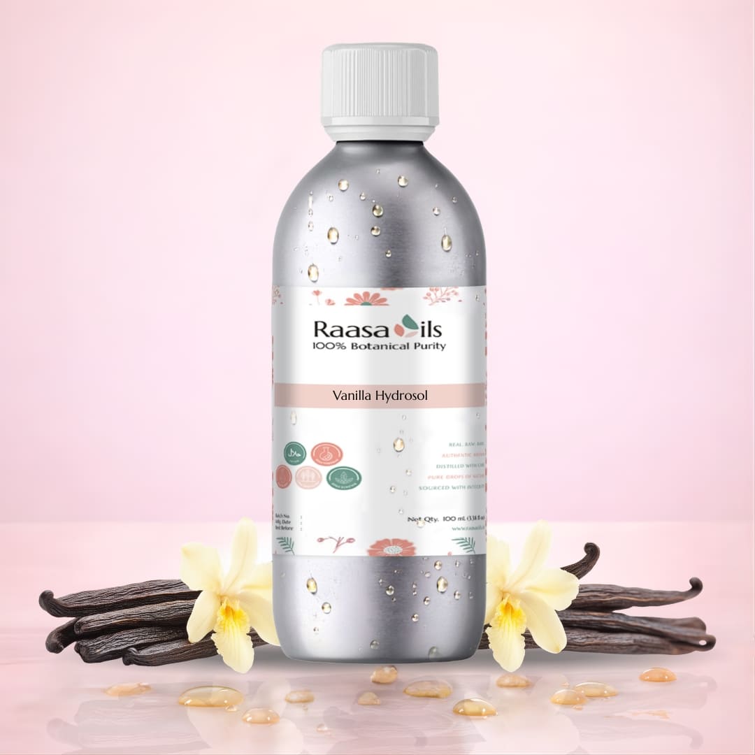 Raasa Oils Vanilla Hydrosol bottle with vanilla beans and flowers on a pink background