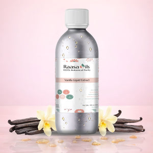 Bottle of Raasa Oils Vanilla Liquid Extract with vanilla flowers and pods on a pink background