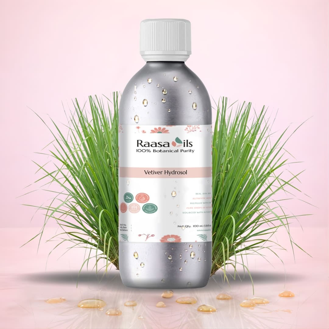 Bottle of Raasa Oils with green leaves on a pink background