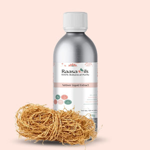 Bottle of Raasa Oils Vetiver Liquid Extract with vetiver grass on a beige background