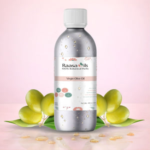 Bottle of Raasa Oils Virgin Olive Oil with olive leaves on a pink background