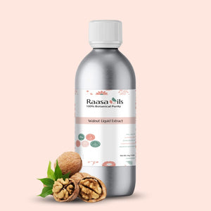 Bottle of Raasa Oils Walnut Liquid Extract with walnuts and leaves on a light pink background
