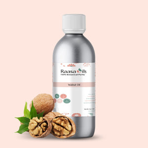 Bottle of Raasa Oils Walnut Oil with walnuts and leaves on a light pink background