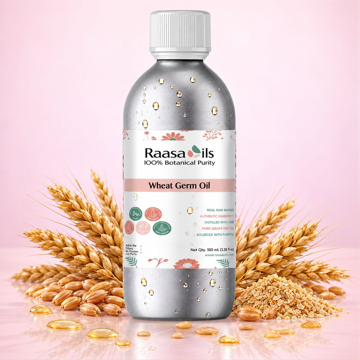 A bottle of Raasa oils Wheat Germ Oil centered on a pink background, surrounded by golden wheat stalks, loose grains, and scattered oil droplets. The bottle is metallic silver with a white cap and a white label featuring pink and green accents.