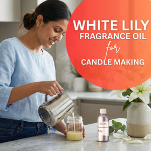 Woman pouring liquid into a jar with a bottle of white lily fragrance oil and flowers in the background.