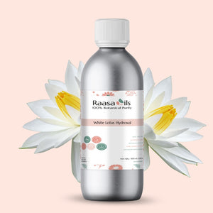 Bottle of Raasa Oils White Lotus Hydrosol with white lotus flowers on a light pink background
