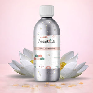 Bottle of Raasa Oils White Lotus Hydrosol with white lotus flowers on a pink background